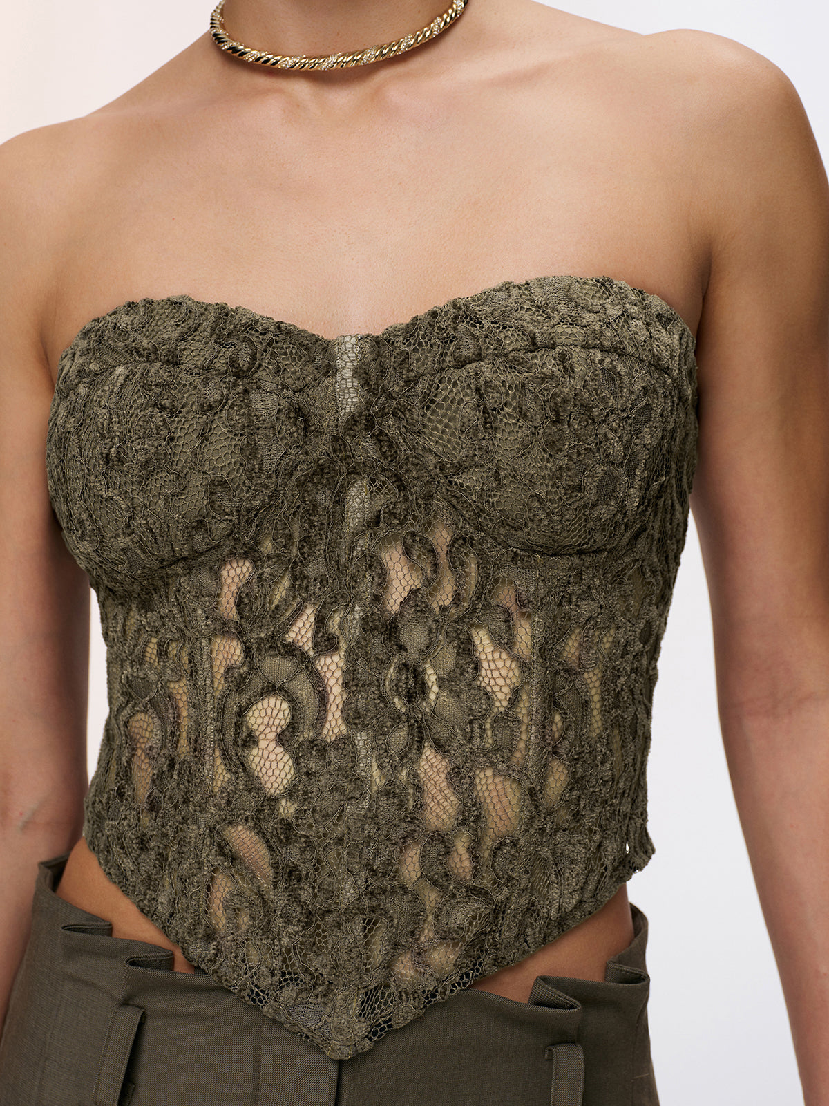A strapless lace bustier top in a romantic style, designed as a corset.