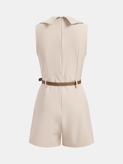 A beige sleeveless blazer romper with pointed collar, back zipper, brown waist belt, tailored shorts.