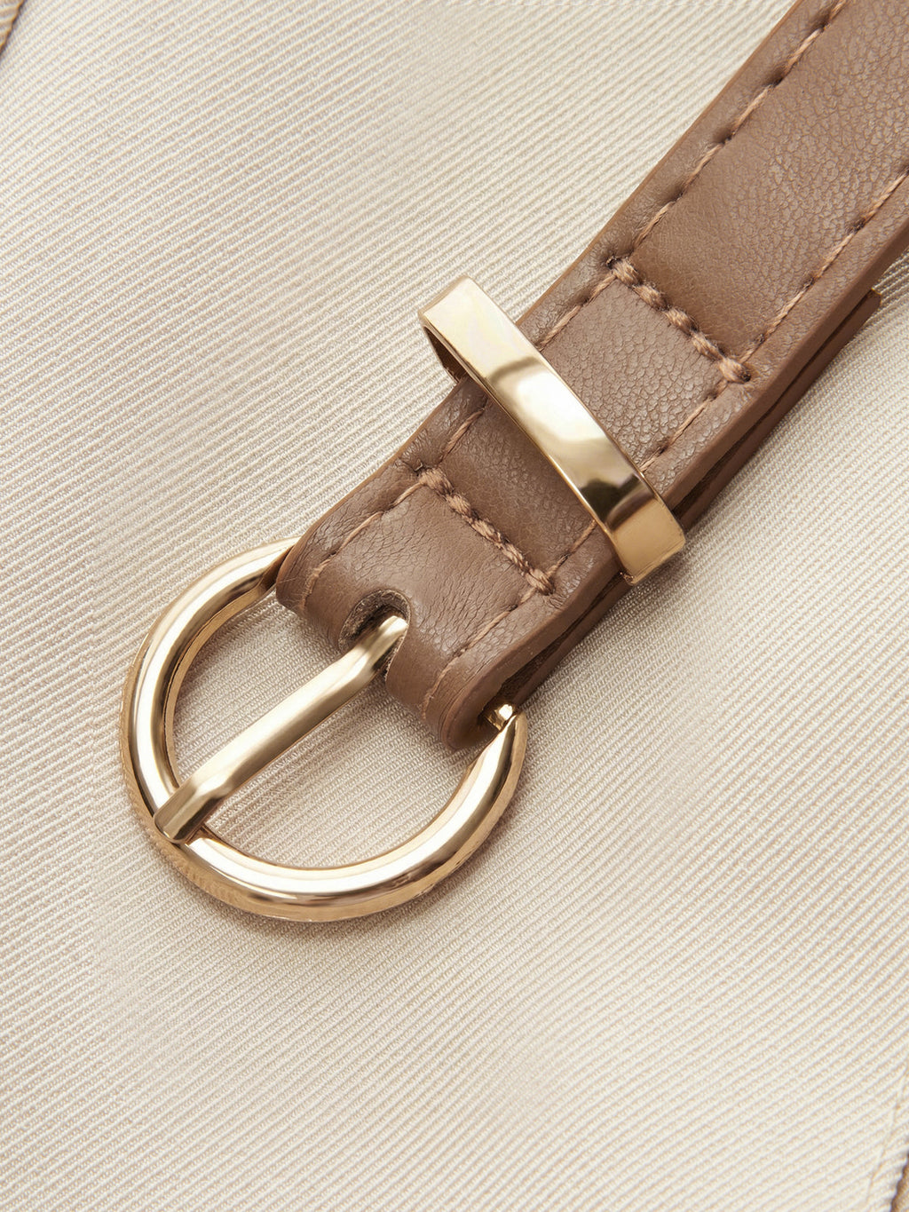 Light beige LA FINE FLEUR sleeveless belted blazer romper with a tan leather belt.