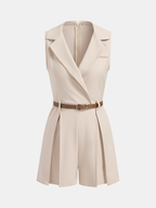 Beige sleeveless belted blazer romper with lapel collar, V-neck, chest pocket, and pleated shorts.