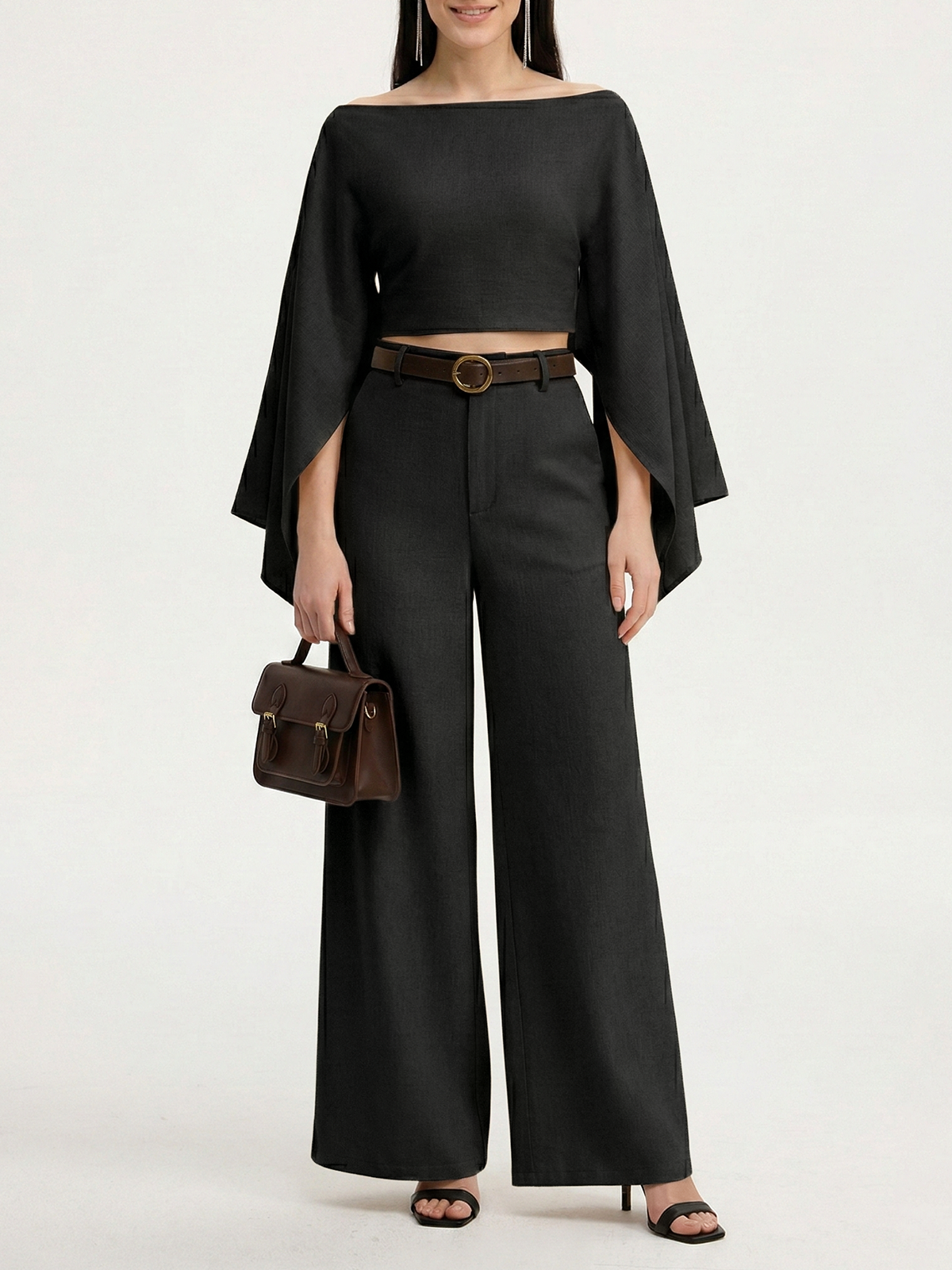 LA FINE FLEUR linen crop top with bold sleeve accents and high-waisted wide-leg black pants.