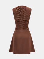 Brown satin cocktail dress with cowl neck, ruched back, fitted waist, and flared mini skirt.