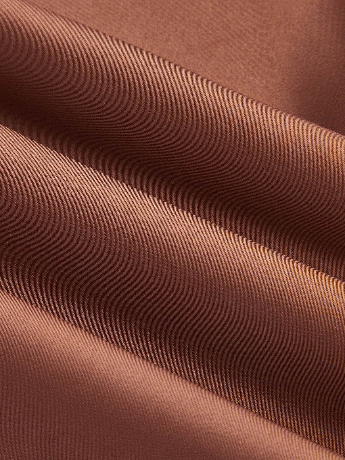 Brown satin cocktail dress with soft folds and sheen, showcasing its luxurious, elegant texture.