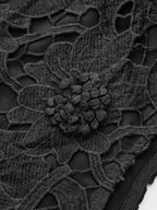 Sleeveless crop top with floral lace embellishments, chic and elegant in design.