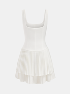 Chic white sleeveless mini dress with square neckline, fitted bodice, and layered pleated skirt.