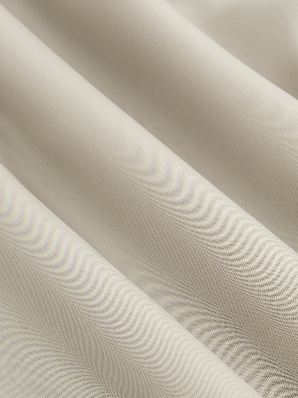 Asymmetrical satin blouse in light beige with draped ruching and elegant diagonal folds.