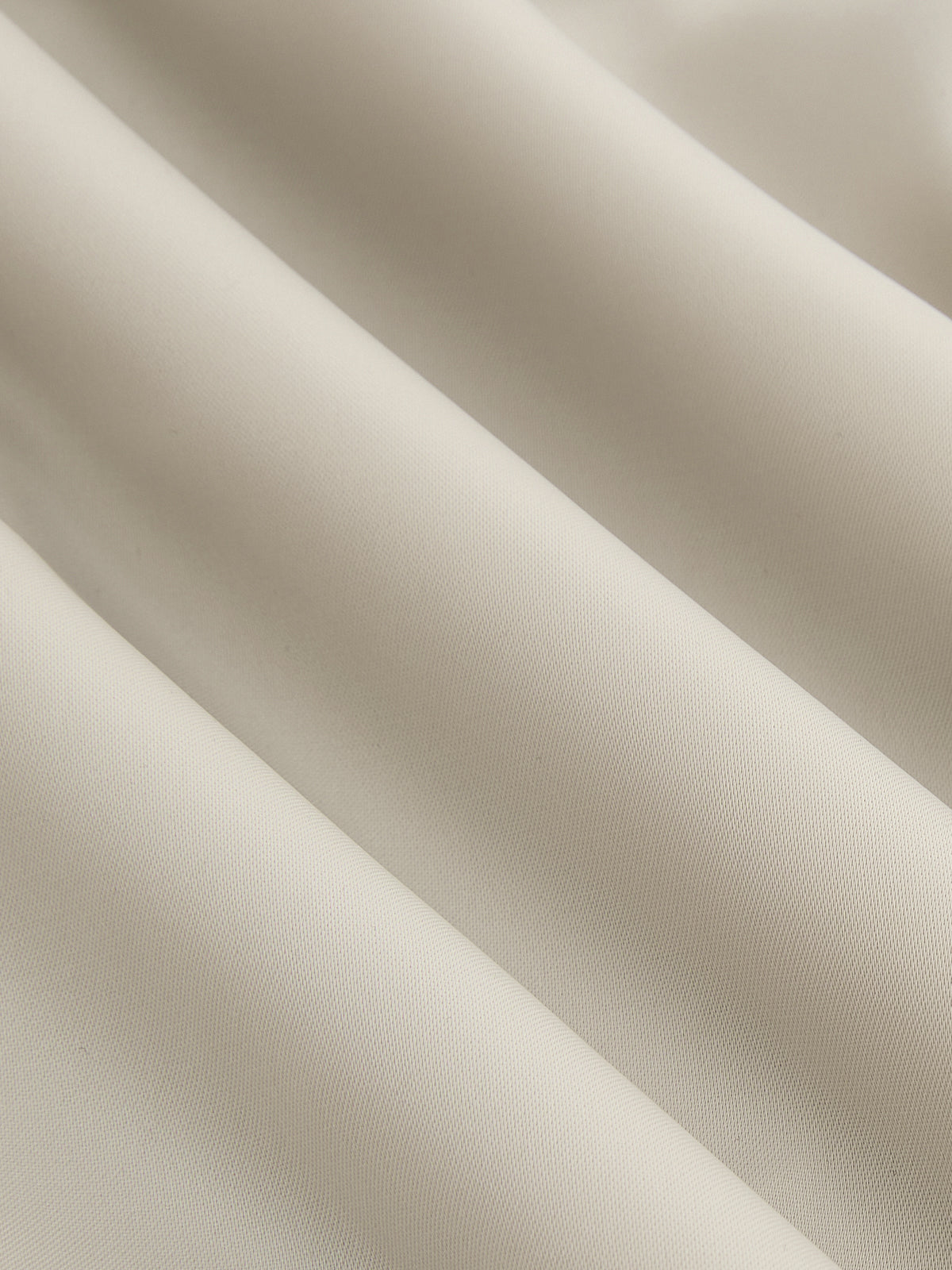 Asymmetrical satin blouse in light beige with draped ruching and elegant diagonal folds.