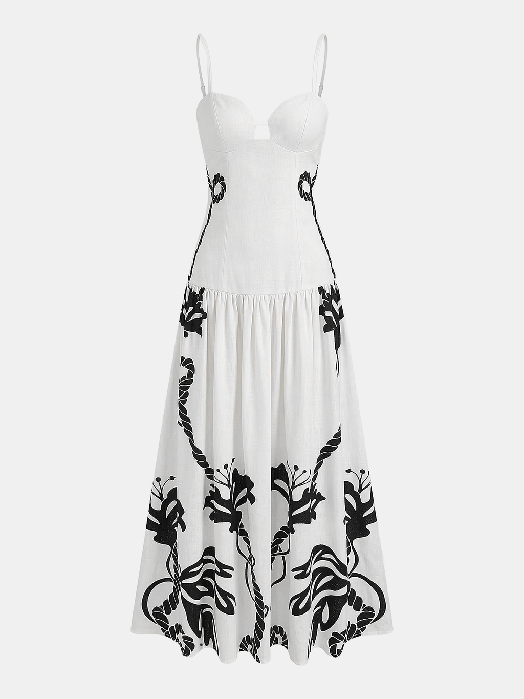 Sleeveless white camisole dress with slim straps and bold black floral vine lower pattern.
