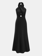 Cotton linen maxi dress with halter neck cut-out, fitted waist, and flowing skirt.