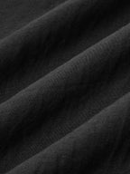 Black cotton linen maxi dress with visible textured weave and softly folded halter neck.