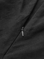 Partially unzipped black zipper on cotton linen maxi dress, highlighting fabric texture.