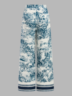 Knotted crop top and wide-leg, high-waisted patterned pants with blue pastoral print and stripes.