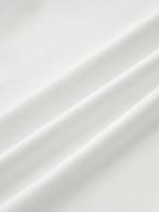 Mock neck sleeveless top in smooth white fabric with ruched detail and soft diagonal folds.