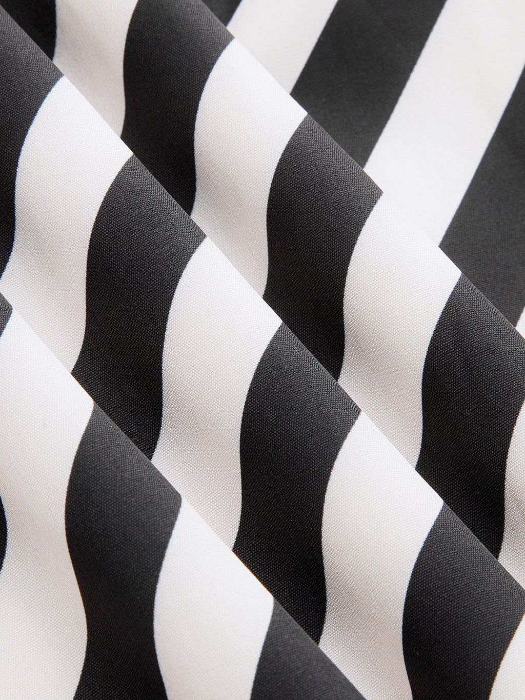 Close-up of LA FINE FLEUR halter neck maxi dress with bold black-white diagonal stripes.