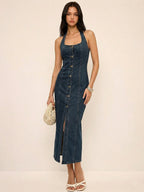A denim halter dress featuring a button-front maxi design with subtle structured tailoring.