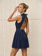 Sleeveless denim mini dress with an open back and modern, streamlined design details.