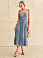 A denim midi dress with tie straps and a tiered design from LA FINE FLEUR.