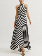 A backless halter maxi dress with bold black and white chevron stripes and fitted waist.