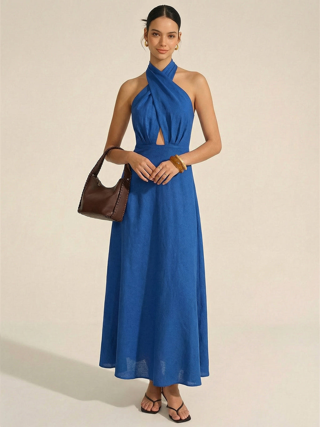 LA FINE FLEUR Cotton Linen Maxi Dress featuring a halter neck and front cut-out.