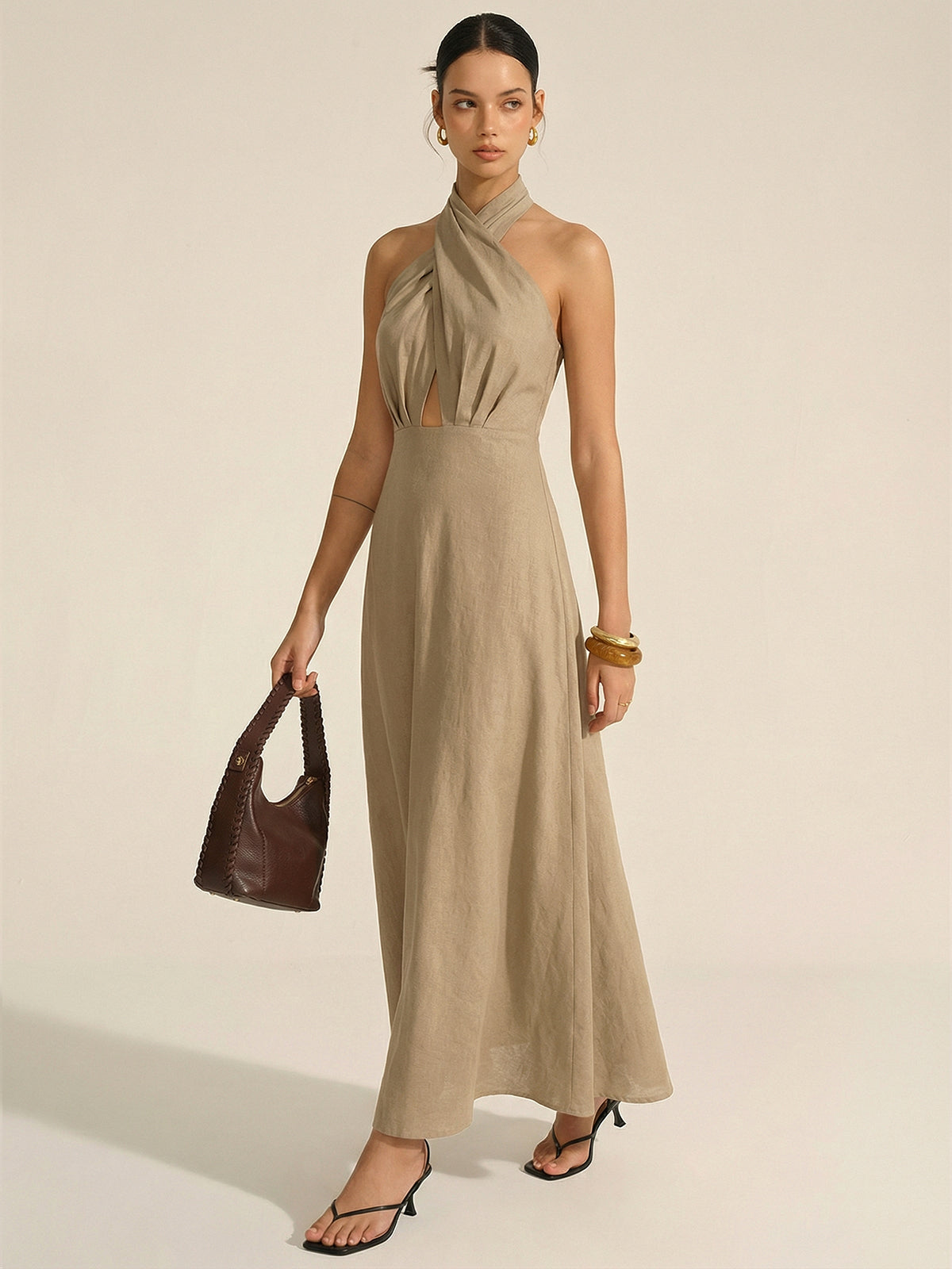 LA FINE FLEUR cotton linen maxi dress featuring a halter neck and front cut-out.
