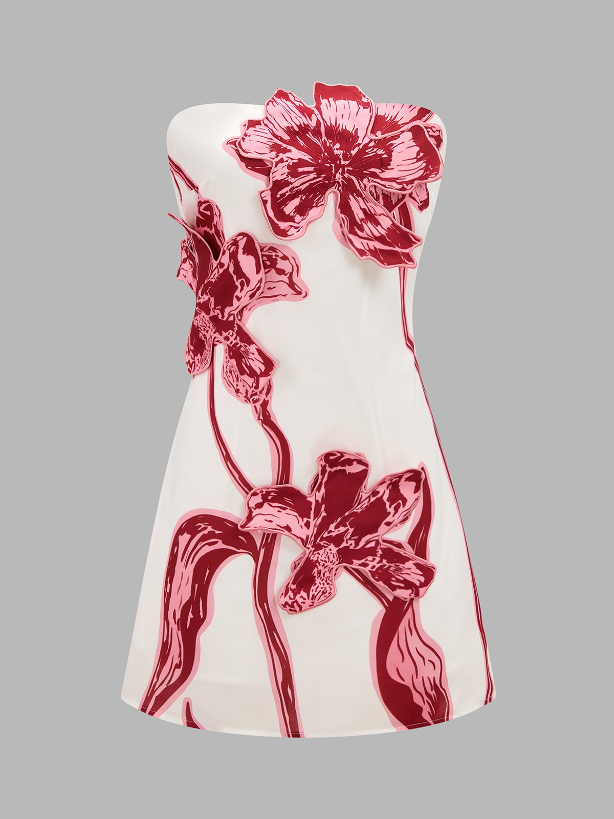 Chic white strapless mini dress with large red floral patterns and 3D flower appliqués.
