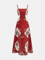 Sleeveless tropical print cami dress with cut-out, adjustable straps, and flared maxi skirt.