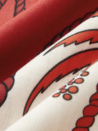 Red and white cami dress fabric with bold abstract pattern, black outlines, dotted accents.