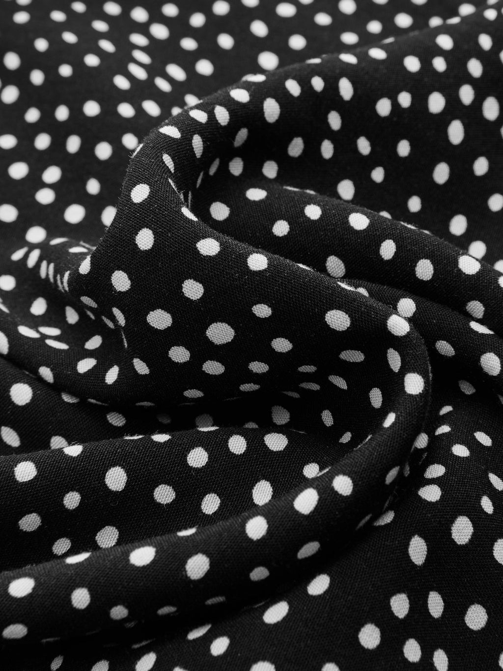 Black lace V-neck midi dress with polka dot pattern, soft fabric, and gentle folds.