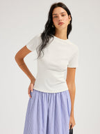 LA FINE FLEUR Open Back Ribbed Top with Short Sleeves and blue and white striped skirt.