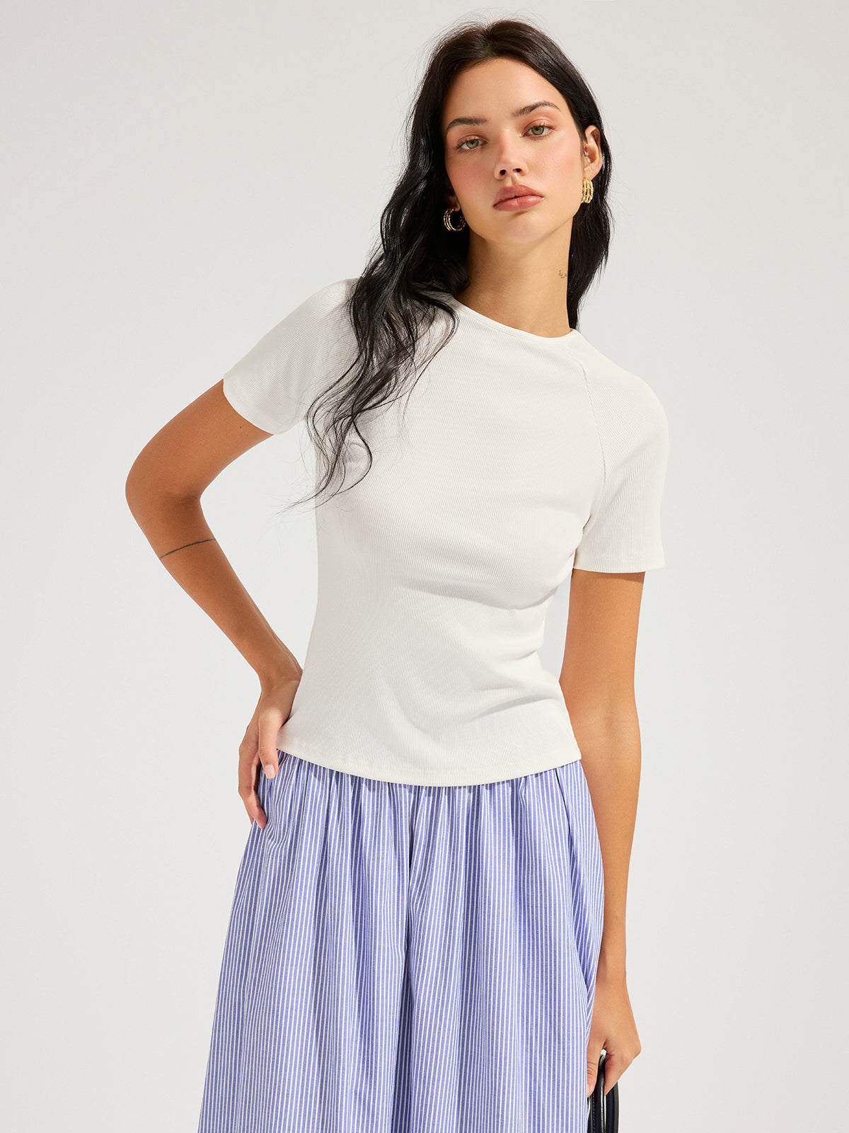 LA FINE FLEUR Open Back Ribbed Top with Short Sleeves and blue and white striped skirt.
