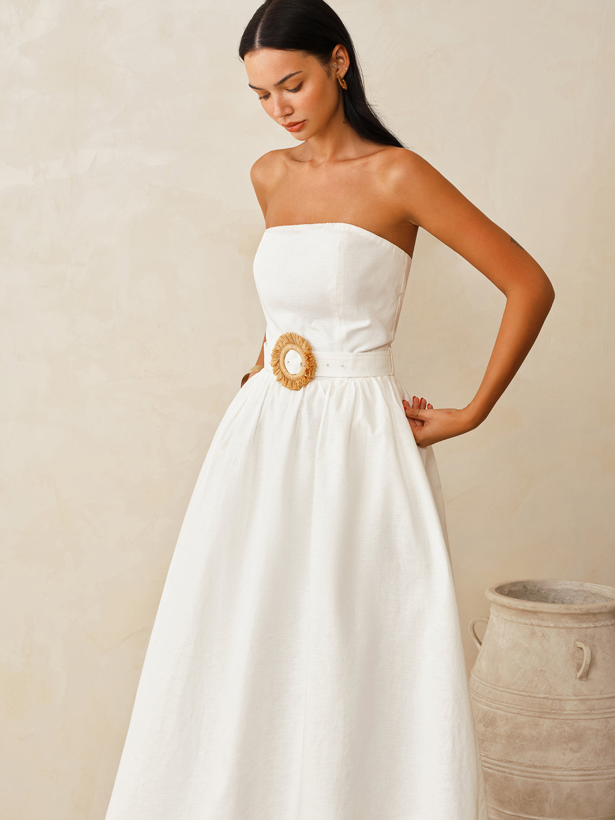 A cotton linen strapless maxi dress with a belt from LA FINE FLEUR, elegant silhouette.
