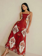 Sleeveless red and white tropical print cami dress with cut-out detail and sleek silhouette.