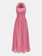 A pink, sleeveless maxi dress with a ruched bodice and softly pleated, crinkled skirt.