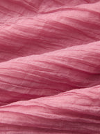 Soft, crinkled maxi dress with gentle folds and layered woven textures throughout the fabric.