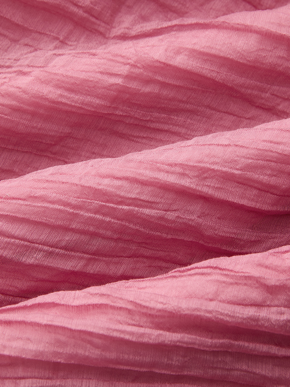 Soft, crinkled maxi dress with gentle folds and layered woven textures throughout the fabric.