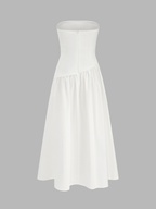 White strapless A-line maxi dress with fitted bodice, flared gathered skirt, concealed zipper.