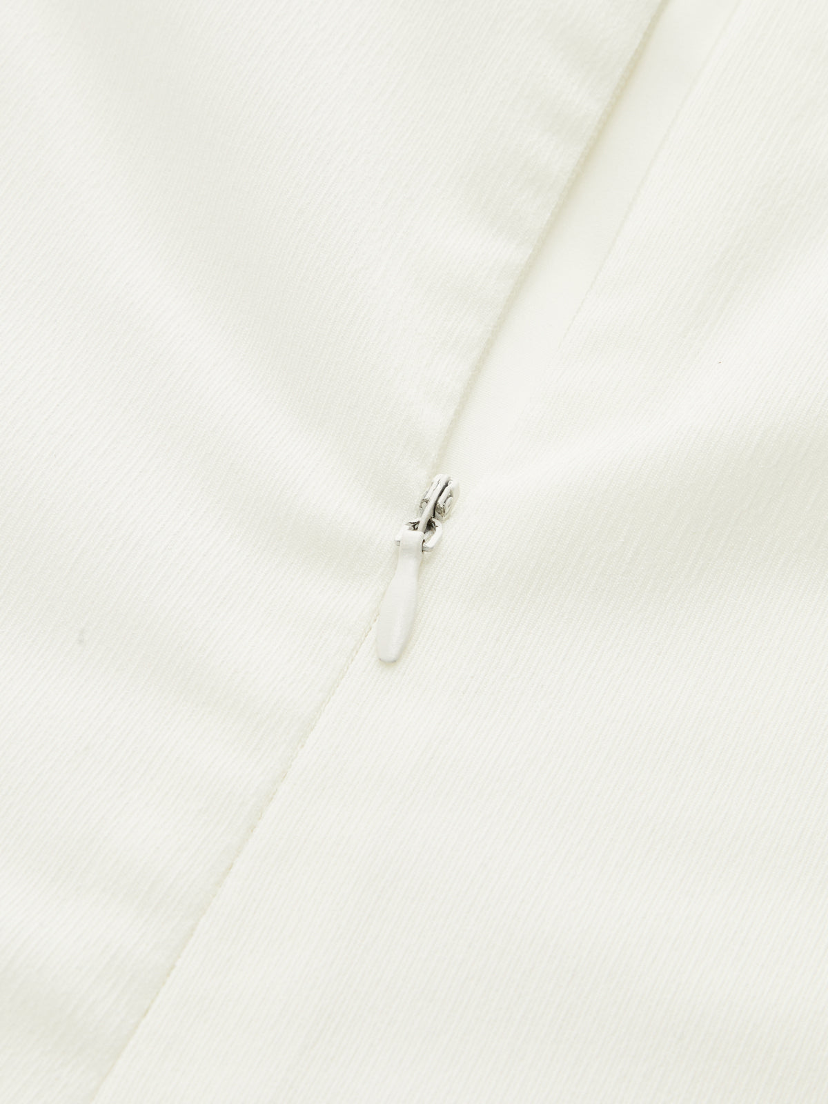 Strapless white maxi dress featuring elegant ruching and a flowy, formal silhouette.