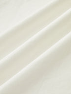 A strapless white maxi dress with ruched fabric and soft diagonal folds, minimalist design.