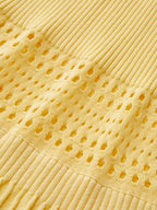 Yellow ribbed knit dress with openwork perforated section for a textured, airy style.