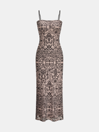 Flowy sleeveless maxi dress with thin straps, black floral geometric print on nude.