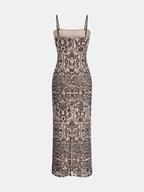 Flowy sleeveless maxi dress with camisole top, black straps, beige base, lace patterns, front slit.