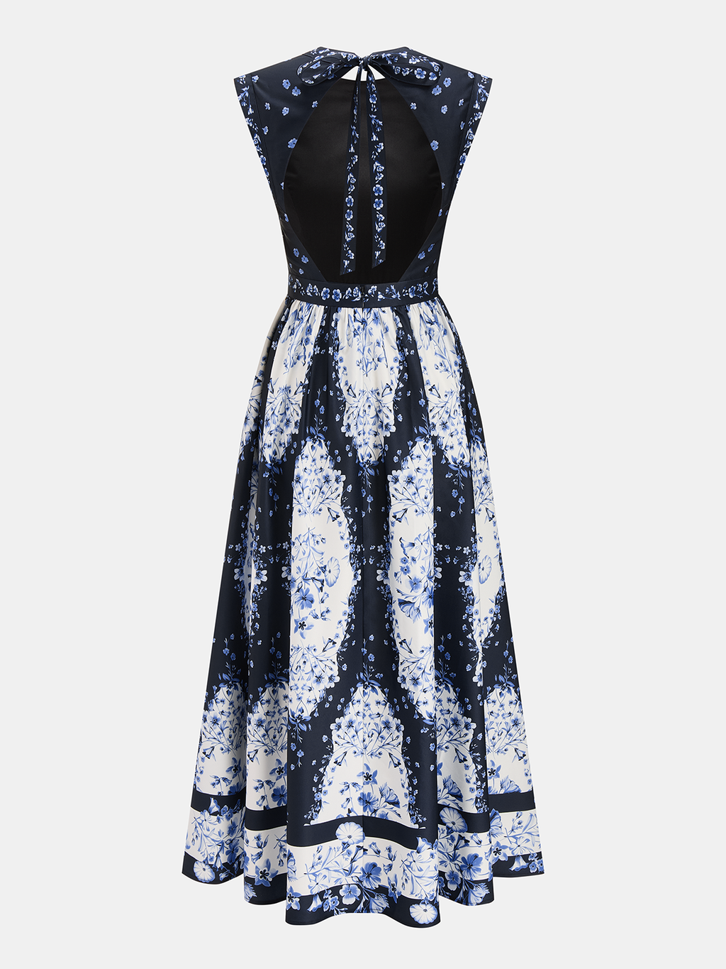 A navy and white floral maxi dress with open back, sleeveless cut, and tie-neck.