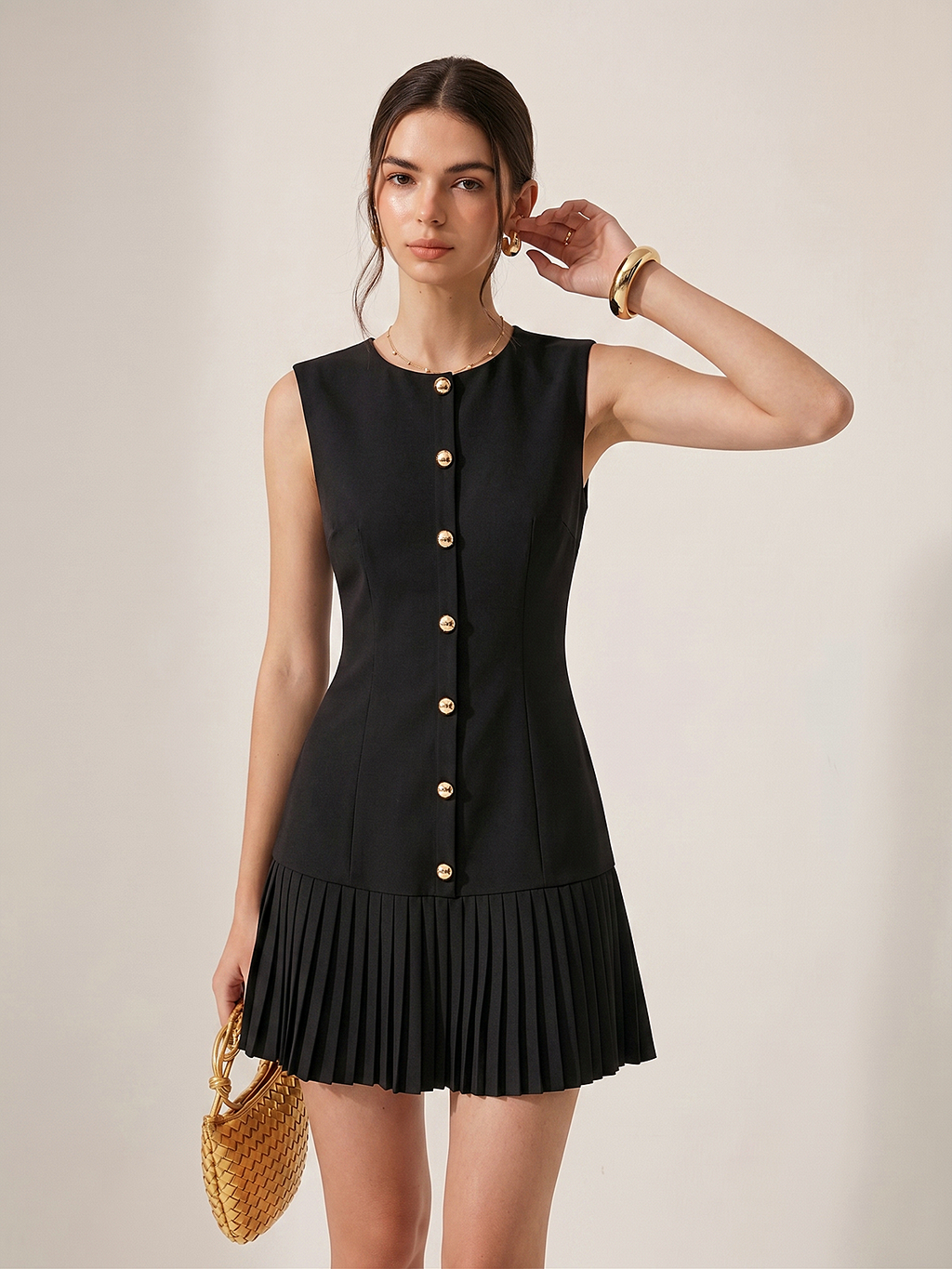 Sleeveless mini dress with metal detailing and pleats, designed for a slim silhouette.