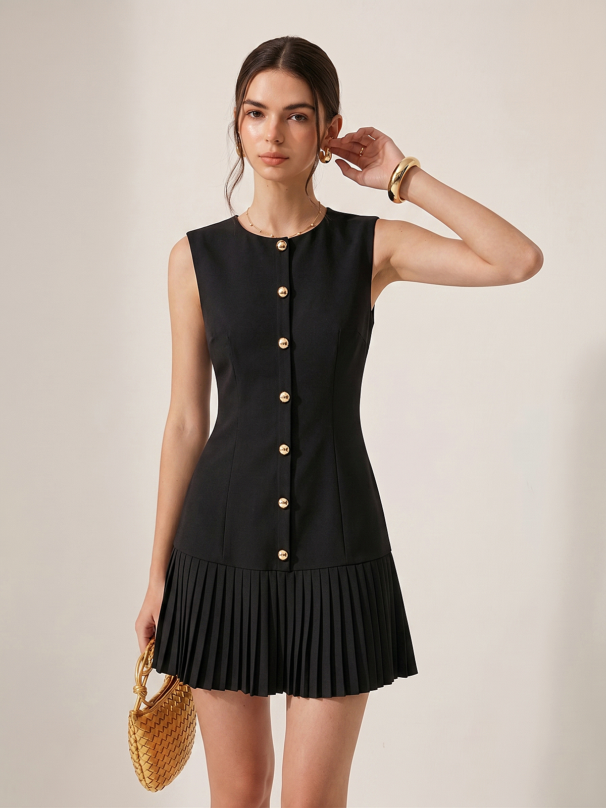 Sleeveless mini dress with metal detailing and pleats, designed for a slim silhouette.