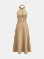 A maxi dress with collared halter neckline, backless belt, button front, and flared skirt.