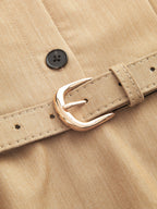 Tan fabric belt with gold buckle on LA FINE FLEUR collared halter maxi dress.