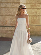 A LA FINE FLEUR strapless ruched maxi dress with a flowy, elegant design.