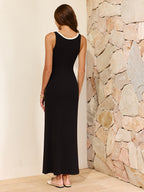 A maxi dress with contrast trim and cut out details in a flowing, stylish design.