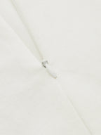 Close-up of LA FINE FLEUR Contrast Stitch Midi Dress with buttoned cami and white zipper.