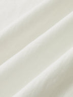 White ribbed cotton-blend cami dress with buttoned front and soft, elegant folds.